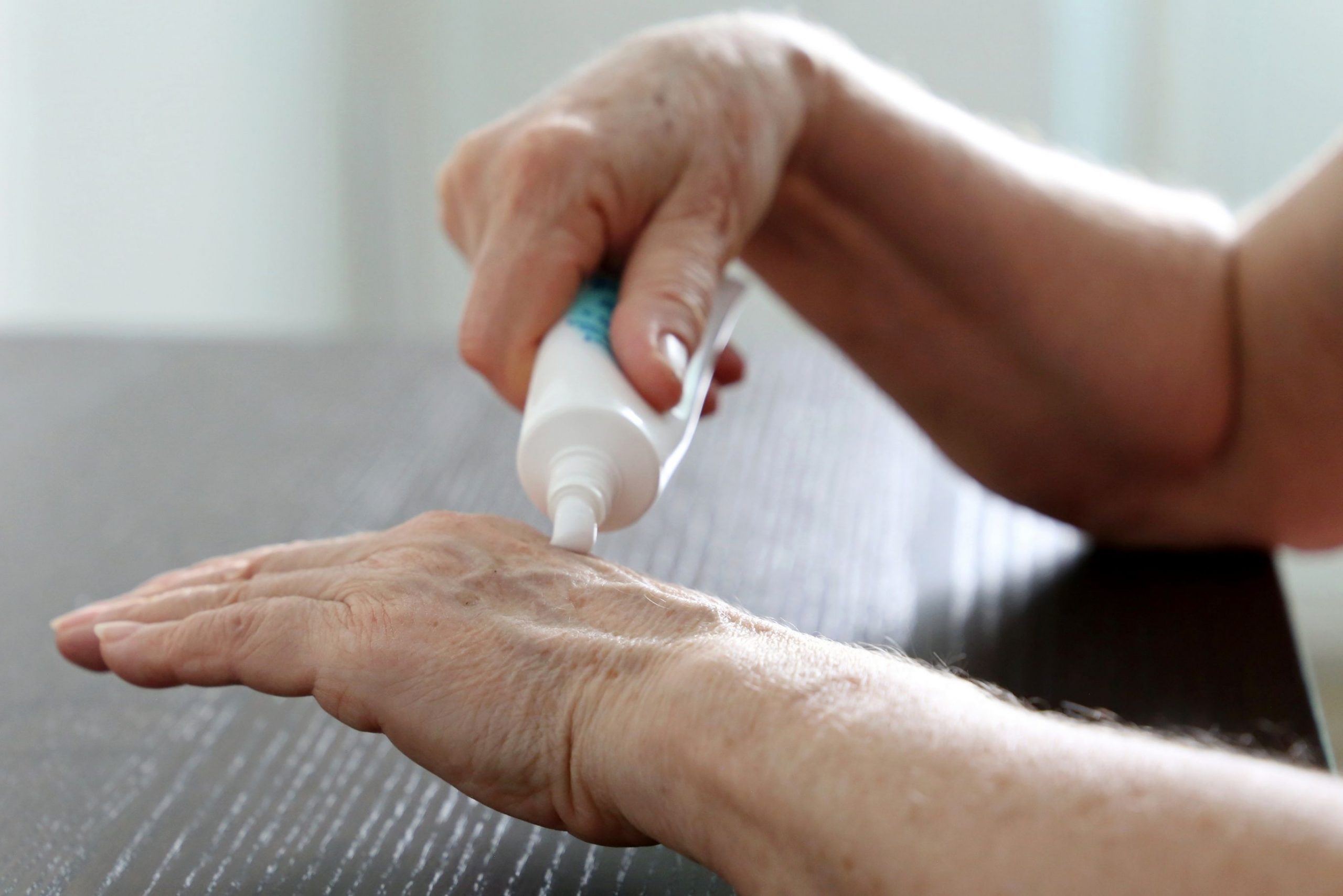 Persona Anziana si applica una crema